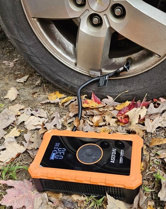 Pumping up a car tire.