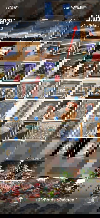 Tapping dot button in Photos app on iPhone.