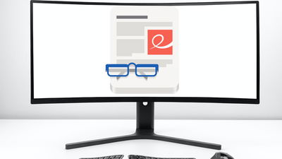 A photograph of a monitor in front of a white wall.