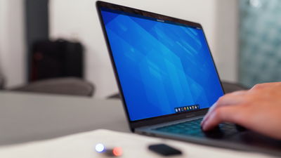 A photograph of a laptop with a GNOME desktop on its monitor.