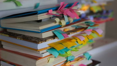 Stack of books with bookmarks.