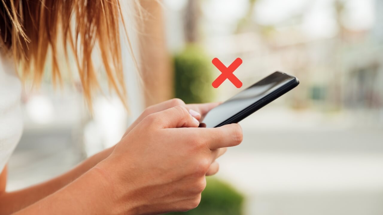Young Woman Holding Black Smartphone